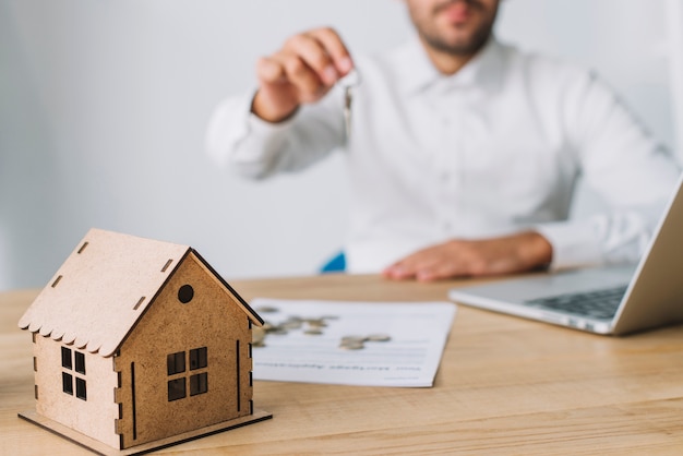 house near real estate agent with keys