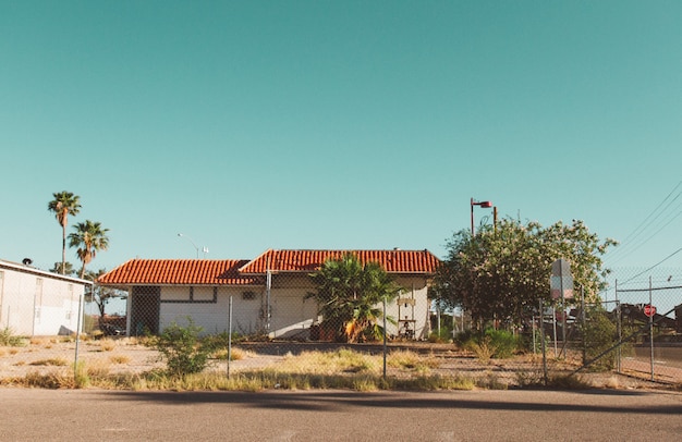 House with a fence around it with a clear sky