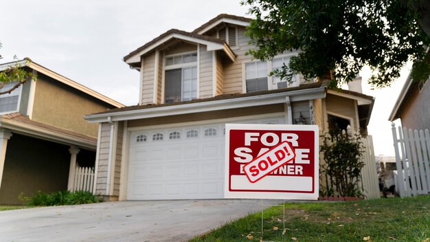 House with sold yard sign