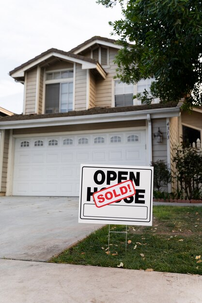 House with sold yard sign