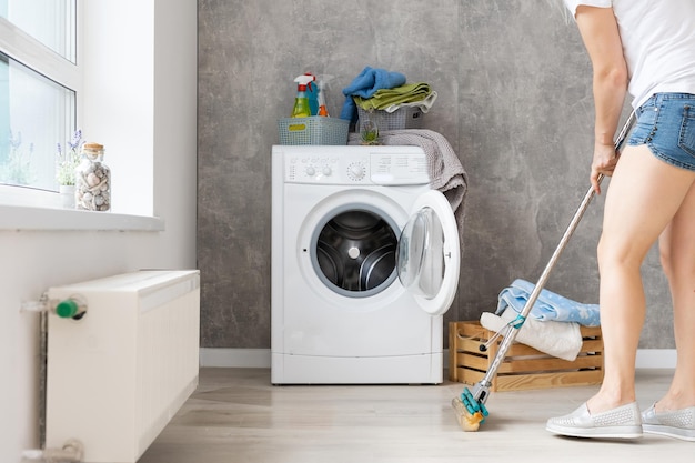 Housework, young woman doing laundry