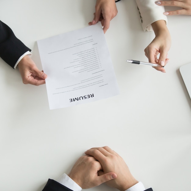 Hr reading applicants resume at job interview, top closeup view