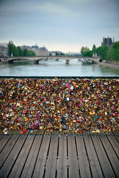 Free photo huge amount of padlocks on bridge over river seine in paris