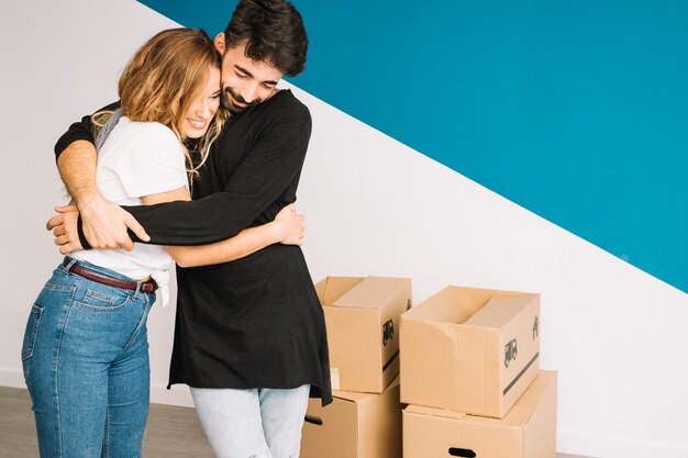 Hugging couple moving to new flat