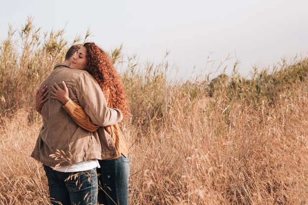 Hugging couple in wheat field