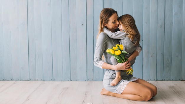 Hugging mother and daughter celebrating mothers day