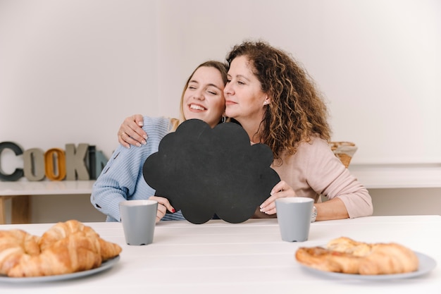 Free photo hugging mother and daughter with speech balloon