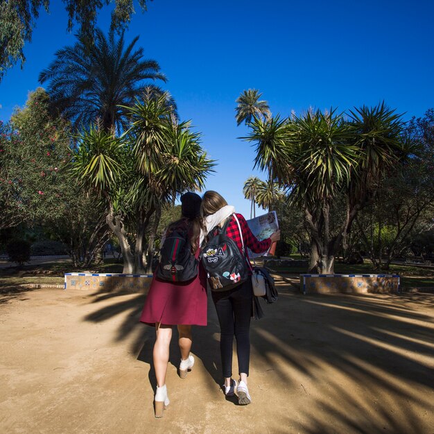 Hugging women walking in park