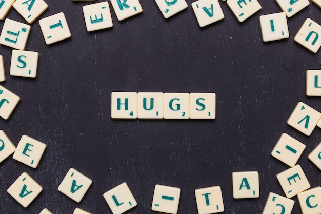 Hugs text arranged in a row over black background