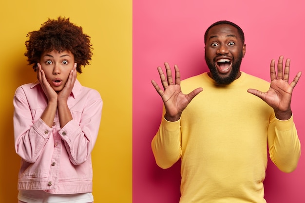 Free photo human face expressions and emotions concept. studio shot of surprised afro american woman holds palms on cheeks