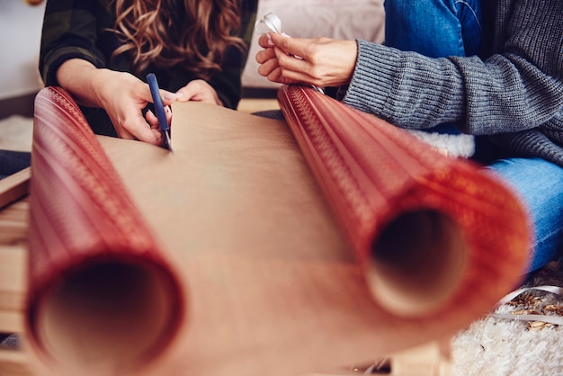 Human hand cutting christmas paper