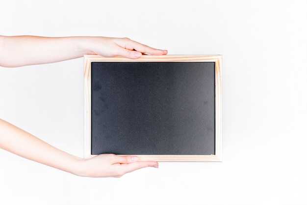 Human hand holding black slate against white background