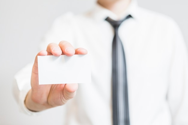 Human hand holding blank business card