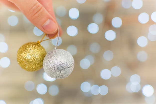 Human hand holding ornament baubles 