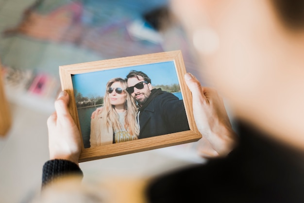 Human hand holding photo frame