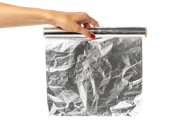 Free photo human hand holding a roll of foil on a white background