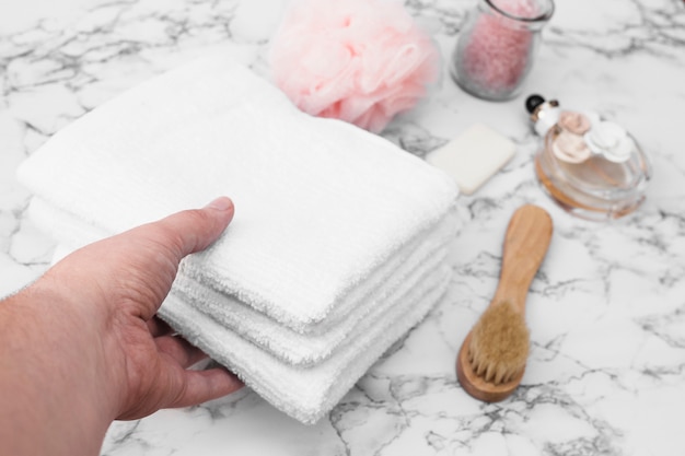 Human hand picking stack of towels