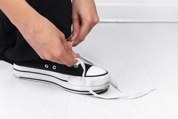 Human hand tying shoelace