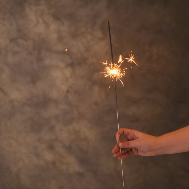 Human hand with flaming Bengal light in fog