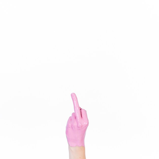 Human hand with pink paint showing middle finger