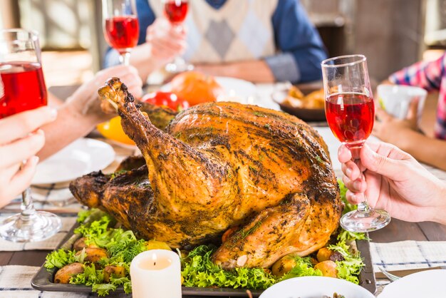 Free photo human hands holding glasses at table with food