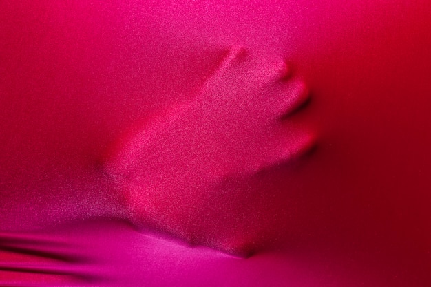 Human palm touching magenta cloth