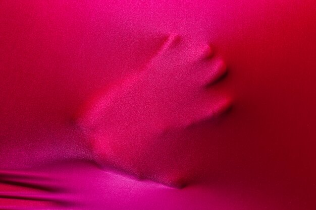 Human palm touching magenta cloth