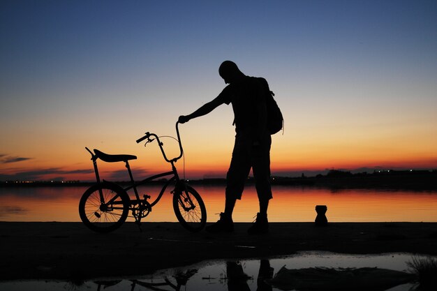 Human silhouette in sunset sky