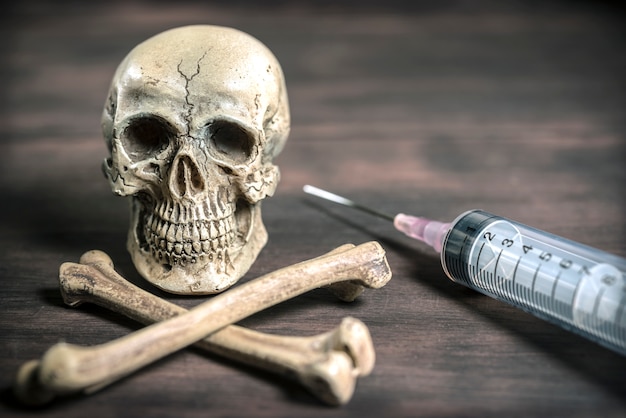 Human skull and crossbones drug addict concept
