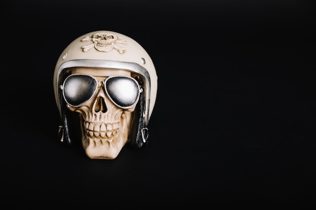 Human skull wearing helmet and sunglasses