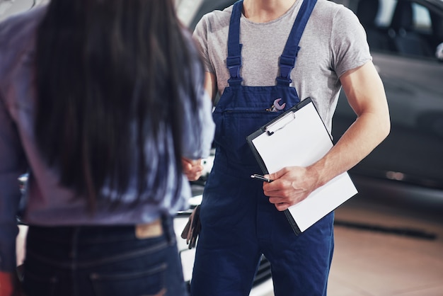 husband car mechanic and woman customer make an agreement on the repair of the car