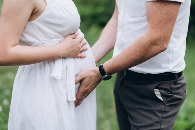 The husband embarcing wife's stomach