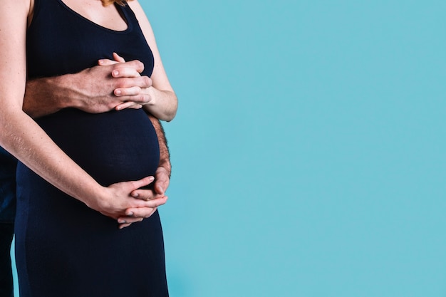 Husband hugging pregnant woman