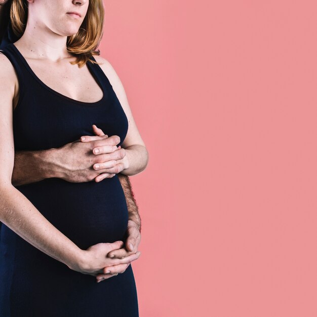 Husband hugging pregnant woman