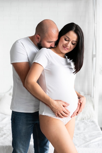 Husband kissing his pregnant wife