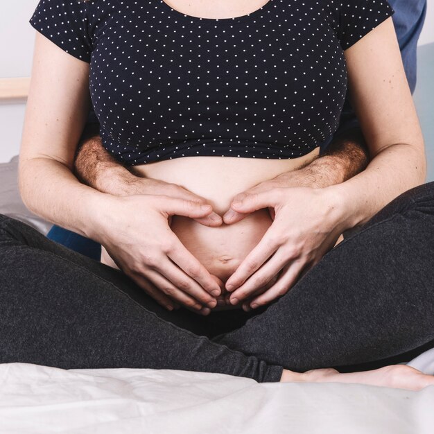 Husband sitting behind pregnant woman