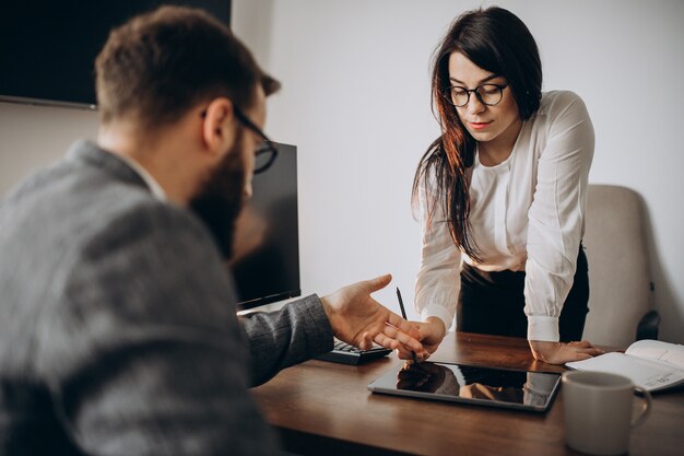 Husband and wife business partners working in office