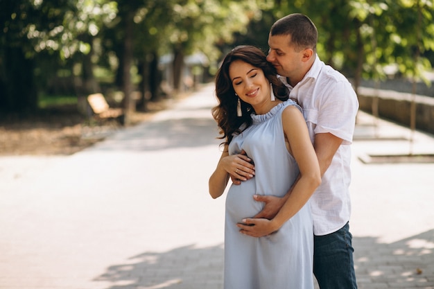 Husband with his pregnant wife in park