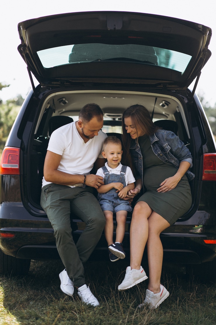 Free Photo husband with pregnant wife and their son sitting in car