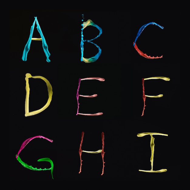 A to I Alphabets formed by multi colored watercolor on black background