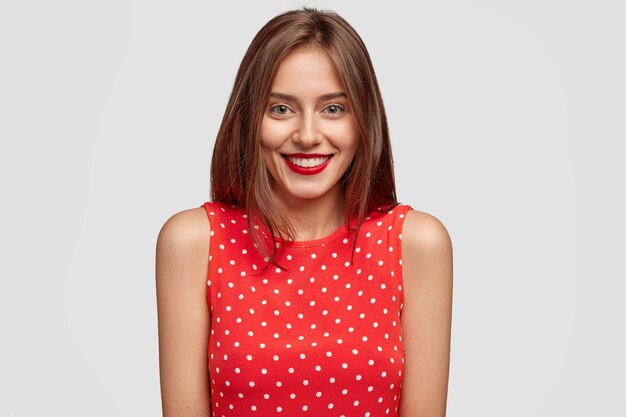 I am ready to listen your idea. Happy student in elegant clothes, has red lips, charming smile