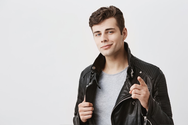 Free Photo i choose you. handsome attractive male in stylish black leather jacket points fore finger , looks confidently. caucasian attractive guy selects someone or advertises something