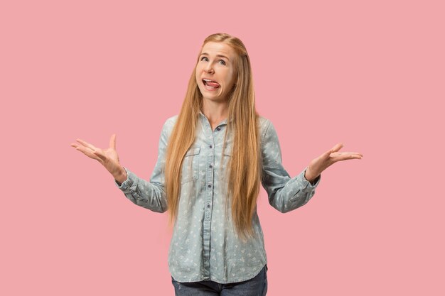 I lost my mind. The squint eyed woman with weird expression. Beautiful female half-length portrait isolated on pink studio backgroud. The crazy woman. The human emotions, facial expression concept.