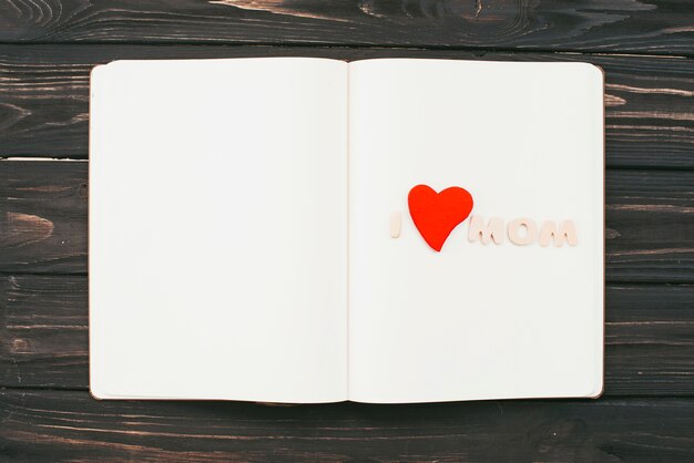 Free photo i love mom inscription on blank notebook