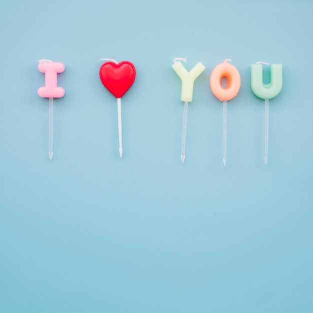 Free photo i love you inscription of colourful candles