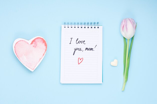 I love you mom inscription on notepad with tulip