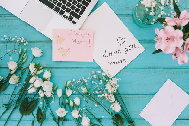 I love you mom inscription with flowers and laptop