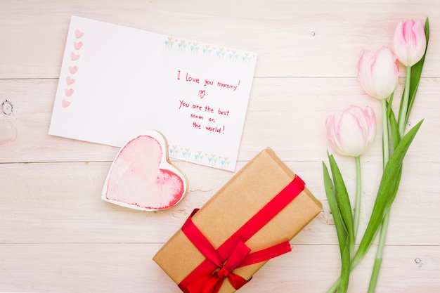 Free photo i love you mommy inscription with tulips and gift