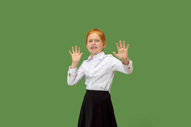 I'm afraid. Fright. Portrait of scared teen girl. She standing isolated on trendy green. Female half-length portrait