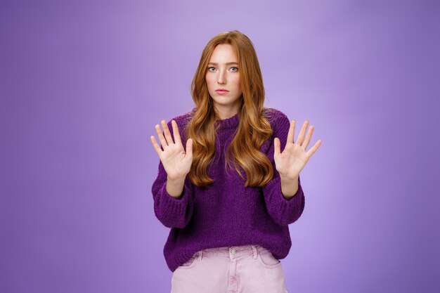 I pass, not even look at me. Portrait of displeased sorrow and intense redhead woman refusing participate in suspicious plan waving hands near chest in rejection looking serious at camera. Copy space